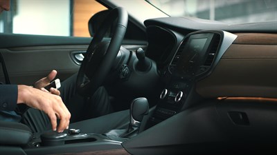 A man pairing his iPhone to the Renault R-LINK Evolution system