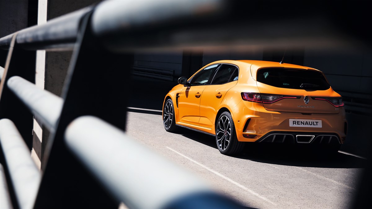 Orange-colored Renault MEGANE R.S. car behind a safety rail