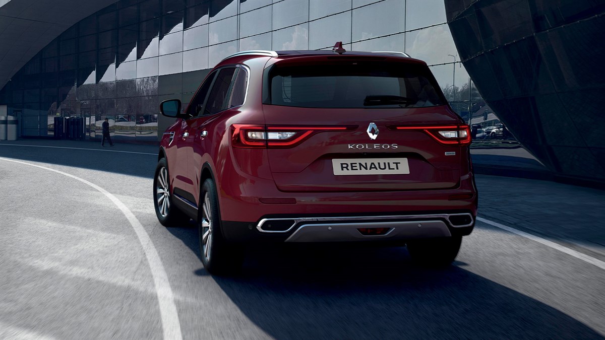 A back view of the wine-colored New Renault KOLEOS running in the city