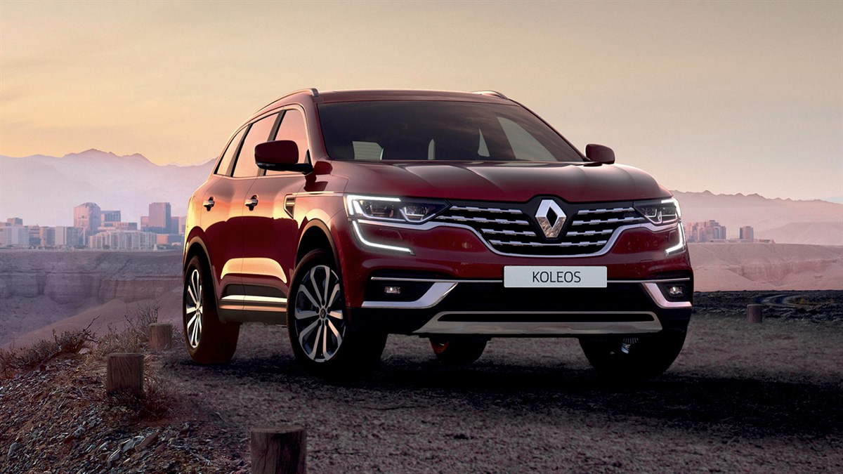 Wine-colored New Renault KOLEOS standing with its LED headlights turned on