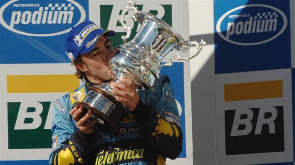 A racer kissing the championship cup