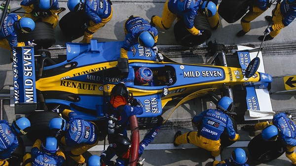 A top view of the Renault F1 car surrounded by its team