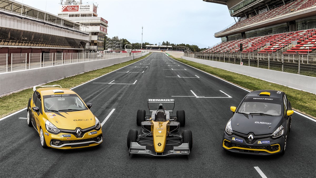 Three Renault Sport series cars parked on a race track