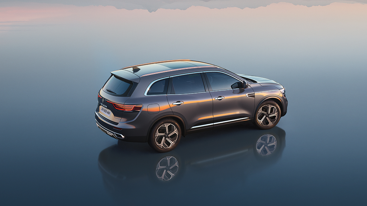 A wine-colored New Renault KOLEOS standing in front corner view with sunlight falling in