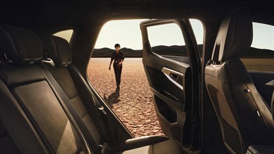 A women looking towards her Renault vehicle
