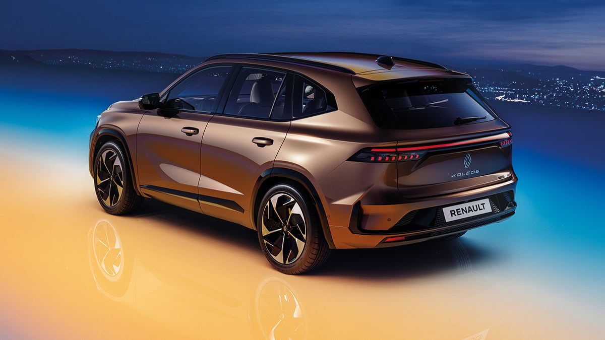 Wine-colored New Renault KOLEOS standing with its LED headlights turned on