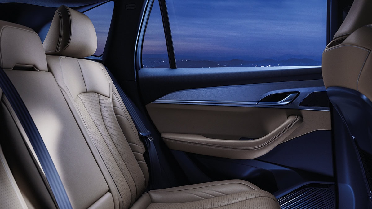 A wine-colored New Renault KOLEOS standing in front corner view with sunlight falling in