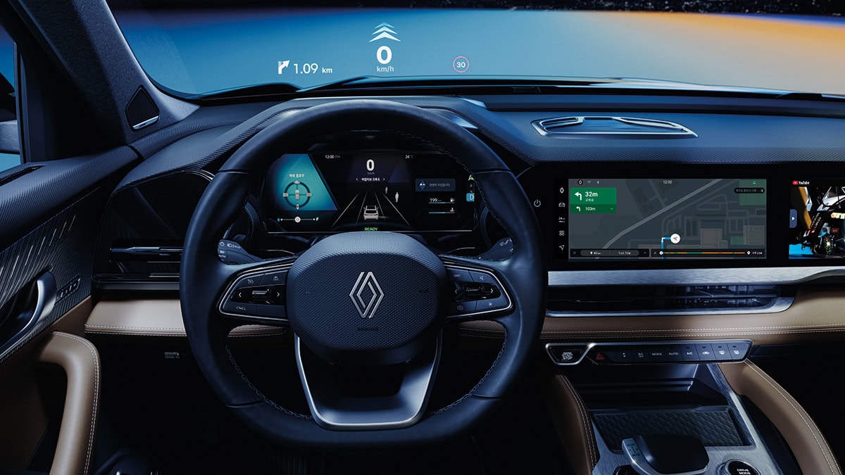 A side view of the wine-colored New Renault KOLEOS running in the hill