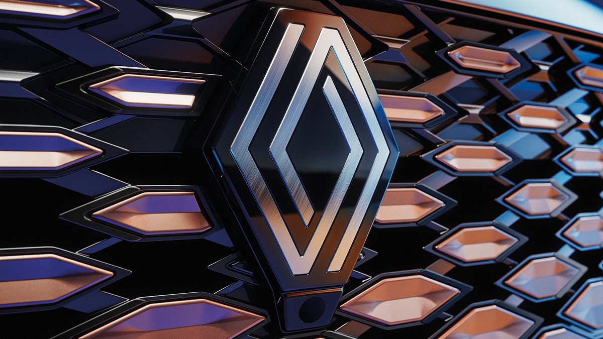 A front corner view of the wine-colored New Renault KOLEOS running slantier in the rocky hill